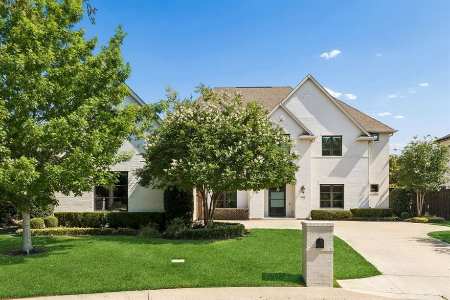 There are many exceptional homes in North Dallas, but few capture the warmth, scale, and livability of this beautifully designed estate. Situated on an expansive half-acre lot, this 5-bedroom, 5 full bath, and 1 half bath residence blends timeless elegance with thoughtful modern functionality. From its charming exterior and welcoming presence to its refined interior finishes, every detail has been carefully curated to create a home that feels both elevated and inviting.
Inside, hardwood flooring flows throughout the main living spaces, complemented by natural light, custom built-ins, and spacious gathering areas designed with comfort in mind. The formal dining room provides an elegant setting for hosting, while the private downstairs office offers a quiet retreat for work or study. At the heart of the home, the chef’s kitchen features granite countertops, an oversized center island, double ovens, extensive built-in storage, and a beautifully appointed butler’s pantry with wine refrigerators.
The main living room is anchored by a striking floor-to-ceiling fireplace and custom built-ins, all framed by stunning views of the backyard oasis. The primary suite serves as a peaceful retreat, featuring a luxurious ensuite bathroom with dual vanities, a soaking tub, walk-in shower, and a walk-in closet with generous shelving and storage. An additional downstairs guest suite with ensuite bath offers ideal flexibility, while a dedicated media room adds another layer of comfort and entertainment.
Upstairs, a secondary living area creates the perfect flex space, accompanied by three generously sized bedrooms, each with its own private ensuite bathroom.
Designed for year-round enjoyment, the backyard offers a true resort-style experience with a covered patio featuring ceiling fans, a stunning lap pool with spa, and expansive grassy areas perfect for play, pets, or outdoor living. An oversized 3-car garage completes this exceptional North Dallas estate.