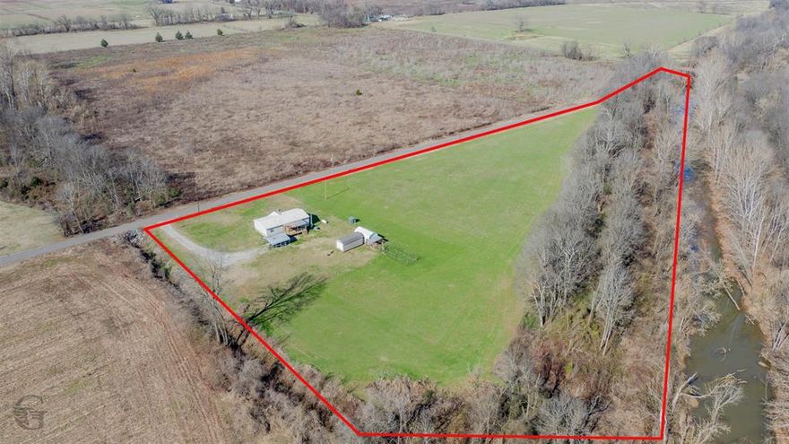 NINE ACRES AND HOME FOR SALE PLAIN DEALING!!!!! Situated on a BEAUTIFUL 9 acres, this 3-bedroom, 2-bathroom, 1,456 square foot manufactured home is ready for its new owner! Offering covered parking and a large, covered porch, this home is a DREAM for those wanting country living and SPACE! Upon entering the home you are greeted with an open living space, perfect for entertaining! The kitchen boasts plenty of storage and an electric range oven, with an eat-in-kitchen. Carpet only in one bedroom! The primary bedroom is LARGE, with a walk-in closet, and spacious ensuite bathroom! The dual sinks, garden tub, and separate shower can suit all preferences and acts as a private retreat! The property also boasts a propane tank and generator! Whatever your needs, this home has it! Schedule your showing TODAY!!!