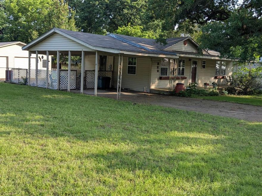 Price Reduction!  Motivated Sellers!  Nestled in a quaint community with a partial view of Lake Tawakoni, this delightful 2-bedroom, 1.5-bath home offers a perfect blend of comfort and charm.  Plenty of space in the large living room for entertaining.  The 9 x 17 eat-in kitchen provides plenty of space for daily meals and casual gatherings, complemented by convenient storage.  Step outside to enjoy the large covered front porch with a small lake view that's perfect for morning coffee or unwinding in the evening. For a little more privacy, you have the option to hang out on the covered patio just off the kitchen.  Property also has an oversized two car garage with an extra storage room and includes a work bench with 220v electricity, 5'x 8' storage area and plenty of space for all those extras.  Fenced in back yard with another outbuilding that is setup for a kennel that includes water.  As a plus, the vinyl siding is low maintenance, and the roof is only 2 years old.
