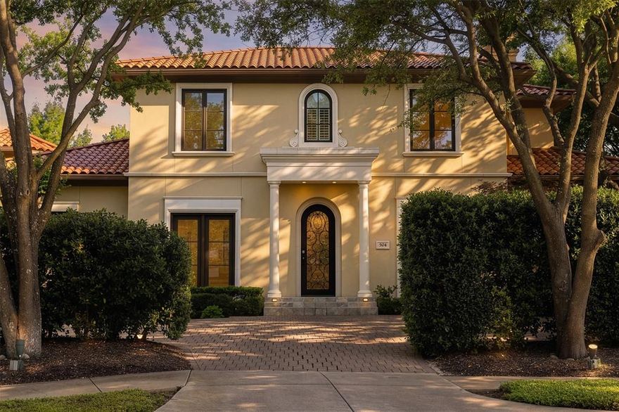 Set within the exclusive guard-gated Enclave at TPC Las Colinas, 504 Byron Court offers a rare blend of privacy, convenience, and resort-style living in one of Las Colinas’ most desirable communities. Ideally positioned on a quiet cul-du-sac, just moments from The Nelson Golf & Sports club that’s easily accessible by golf cart. The home also enjoys close proximity to core Dallas, DFW International Airport, the Toyota Music Factory, and major business corridors. Inspired by Mediterranean design, the residence is framed by lush landscaping and enhanced by added privacy, with mature trees and thoughtfully placed greenery creating a secluded backyard retreat. Expansive glass doors invite natural light throughout, establishing a seamless connection between indoor and outdoor living, where a private yard, spa, and mosquito misting system create an ideal setting for year-round enjoyment. The kitchen has been thoughtfully updated with quartz waterfall countertops, chef-caliber appliances, two under-counter wine refrigerators, and a new full-size refrigerator, offering both function and style for everyday living and entertaining. The reimagined primary suite serves as a true retreat, complete with a private patio, expansive dual vanity, frameless walk-in marble shower, freestanding spa-like bath, and dual walk-in closets. Recent enhancements further elevate the home’s comfort and efficiency, including a new HVAC system, new water heater with recirculation pump, new washer, updated powder room, and wiring for ceiling speakers. With over 3,900 square feet of well-appointed living space, 504 Byron Court offers the ideal balance of sophistication and ease within a secure, amenity-rich community defined by golf, privacy, and accessibility.