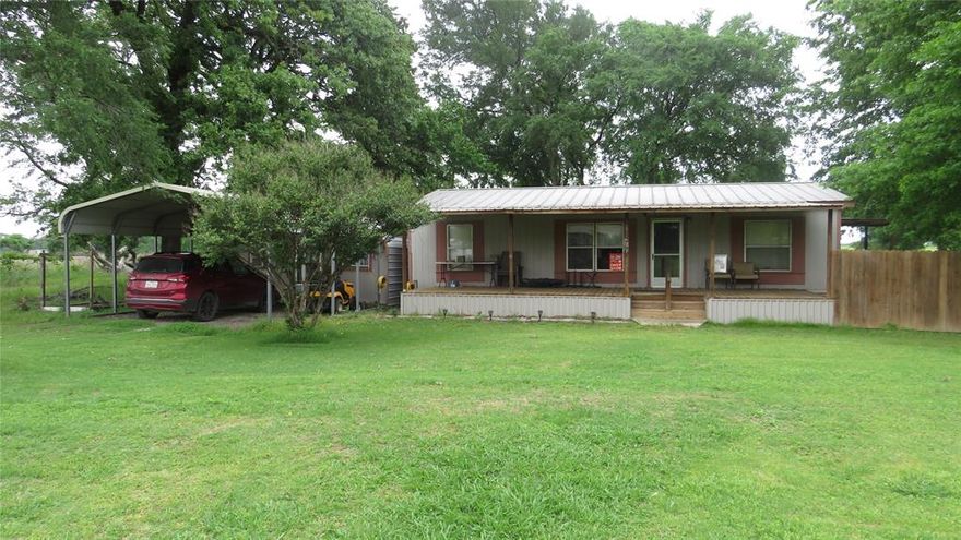 Nice 3 bedroom, 2 Bath Doublewide Mobile Home with a wrap around Porch on almost an acre and a half. Carport and a unattached building, that can be used as a shop. 25' Camper built in 2021 is included in the sale. Also has a RV Carport.  Out in the Country but less than 30min from Oklahoma, Bonham, Lake Bonham and the new Bois D' Arc Lake.