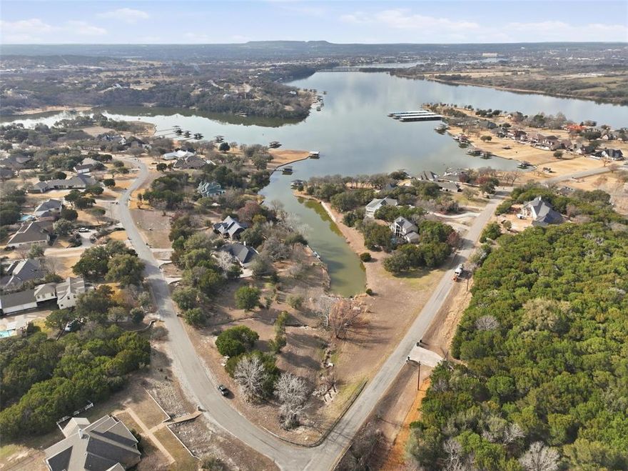 RARE opportunity to own 2.18 acres of prime lakefront property on beautiful Lake Granbury. This expansive lot offers the ideal setting for a luxury custom home, providing privacy, breathtaking water views, and direct access to one of North Texas’ most desirable lakes. With ample space to design a true estate-style residence, this property combines the tranquility of lakeside living with the convenience of nearby shopping, dining, and historic downtown Granbury. Enjoy boating, fishing, and sunset views from your own shoreline. Large lakefront tracts of this size are seldom available—an exceptional opportunity to build an iconic waterfront home. The seller has completed extensive due diligence on this property, including relocating drainage easements to accommodate a larger pad and trenching for water. All costs and quotes can be shared with any agent or interested buyer! Look no more, this is it!