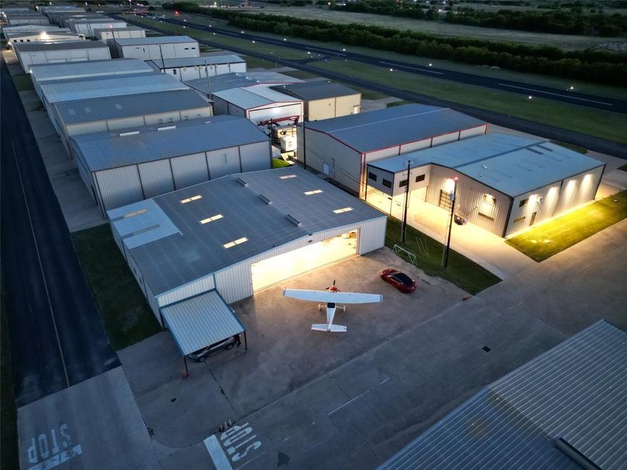 Rare opportunity to own a versatile aviation property at Hicks Airfield FAA identifier T67. Situated on a large corner lot, this impressive 100x70 airplane hangar offers endless possibilities for aircraft storage, business operations, or aviation lifestyle living. The property includes a 1,400 sq ft apartment living area with a bathroom that can easily function as a residence, office, pilot lounge, or guest quarters. Additional features include a 600 sq ft workshop with loft storage, a 52x18 sliding hangar door, expansive concrete parking pad, and additional covered parking. Excellent access and functionality in one of the DFW area’s well-known aviation communities. POA dues are $2,250 annually.