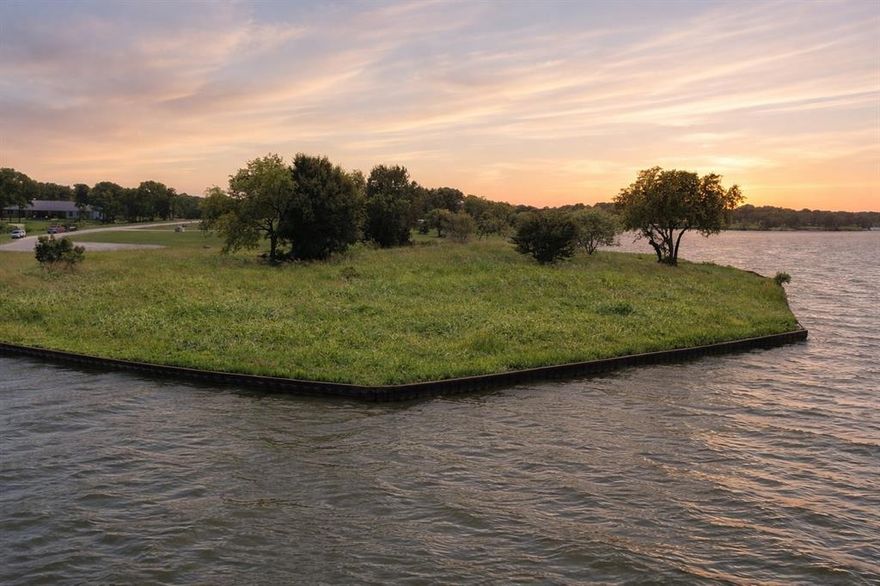 Tucked away at the end of a cul-de-sac in the gated community of Admiral Shores, this incredible 1.16-acre waterfront lot offers the kind of setting that is rare to find. Positioned on a peninsula, the property features an impressive 553 feet of dockable shoreline, wrapping around to deliver wide, open water views from nearly every angle. Whether you're dreaming of lazy mornings with coffee by the water, full days out on the boat, or evenings catching the sunset in total peace, this lot sets the stage for a life that feels like a permanent vacation. The lot is fully cleared and includes a sturdy steel retaining wall, which means you’re one step closer to breaking ground on that custom home you've always envisioned. There’s plenty of space to create something truly special here, whether it’s a sprawling lakeside retreat or a cozy full-time residence with panoramic views from every room. And thanks to the natural curve of the peninsula, you’ll enjoy a level of privacy that’s rare in any neighborhood, especially one with such easy access to deep, open water. Admiral Shores itself is a quiet, gated community that offers a sense of security and exclusivity while still being close enough to nearby conveniences when you need them. It’s the kind of place where neighbors wave from golf carts and starry nights are part of the regular routine. If you’ve been waiting for the perfect waterfront property that combines space, privacy, and unbeatable views, this lot truly checks all the boxes. Come see it for yourself—it just might be the beginning of your next chapter by the lake.