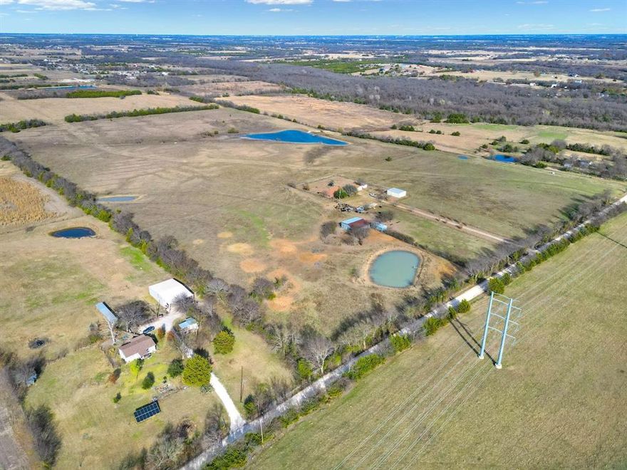 This 62.65-acre property located in Collin County with four ponds, open pasture, and a well-maintained residence, located between Blue Ridge and Farmersville along Highway 78. The land is AG exempt and features rolling terrain, fenced and cross-fenced sections, and a large stocked pond, creating a setting that supports livestock, recreation, or long-term land investment. The property includes a 3,004 square foot home with three bedrooms, two bathrooms, and a detached two-car garage, offering immediate usability while you plan future improvements or expansion. A 30x40 workshop with electricity and a concrete floor provides functional space for equipment, storage, or projects tied to the land. Utilities are in place with rural water, septic system, and co-op electric, and the property has county road frontage with access approximately 0.2 miles from Highway 78. The land is unzoned, allowing flexibility for agricultural use, residential living, or potential development opportunities. Pipeline easements are present. Positioned in a growth path of Collin County near the planned Outer Loop, the property offers a balance of open space and regional access, with Blue Ridge approximately 4 miles away, Farmersville approximately 6 miles away, and McKinney approximately 20 miles away. Opportunities with this combination of acreage, water features, and existing improvements are limited. Schedule a private tour to explore the property and its potential.