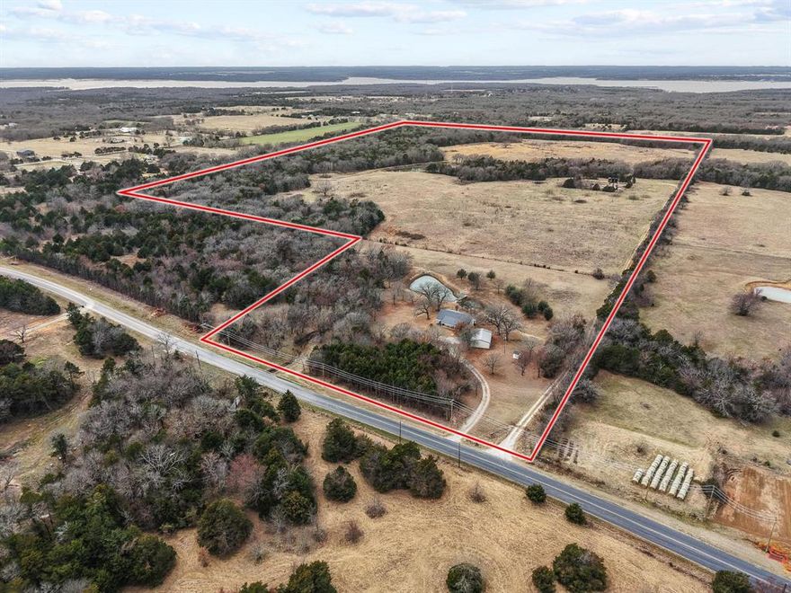 This property is situated in a rapidly growing corridor near Lake Texoma, the acreage presents exciting possibilities for subdivision, ranchette parcels, a private gated community, RV or cabin retreat, or mixed-use recreational development, subject to local approvals. With increased demand for land near the lake and continued growth in the surrounding area, this property offers both immediate usability and long-term upside. Opportunities like this large acreage near the lake with a home ready for your personal touch are increasingly rare. Bring your vision and unlock the possibilities. Sprawling acreage provides room for livestock, horses, hunting, trails, additional structures, or simply enjoying wide-open Texas skies. Mature trees, natural terrain, two ponds, and abundant wildlife create a serene backdrop just minutes from lake recreation, boating, fishing, and growing local amenities. This is an ideal chance to renovate the house and make it your own while adding immediate value. With solid bones and a peaceful rural setting, a little vision will transform this house into a charming country homestead or weekend getaway also. Large shop next to the home for all your projects or storage needs. The 99 acres property offers endless potential for those seeking space, privacy, and most of all opportunity. Whether you're dreaming of a private ranch, recreational retreat, investment project, or future development, this expansive tract delivers the perfect canvas. Available to subdivide if you don't need all 99 acres, contact us for more info.
