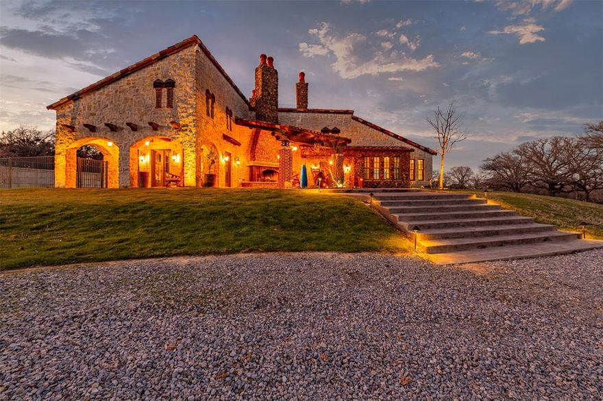 This modern Tuscan masterpiece is not just a home; it's an experience. Built in 2014 on an expansive 12.47 acres, the property offers panoramic views of nature's canvas, featuring a half-acre pond stocked with fish. Architectural brilliance defines this custom-built haven with rock and stone accents both inside and out, Saltillo tile flooring, and three oversized fireplaces that effortlessly blend indoor and outdoor living. The open floor plan seamlessly connects the main living room, kitchen, and dining area, adorned with commercial-grade appliances and an expansive prep island. The primary bedroom is a sanctuary with a loft, en suite with a fireplace, soaking tub, walk-in shower, and a private patio with an outdoor shower. Additional luxuries include a courtyard, outdoor terrace, a 48 x 48 barn with workshop, living quarters and a woodshed with storage. This property is completely fenced with security gate, offering an unparalleled lifestyle blending sophistication with security.