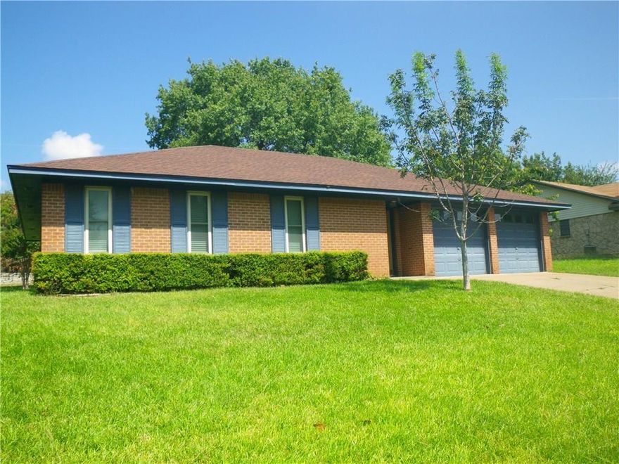 Three bedroom two bath brick home in a great neighborhood. Large living area with wood burning fireplace.  Two car garage. Spacious backyard with scattered trees. House is now ready for showings!