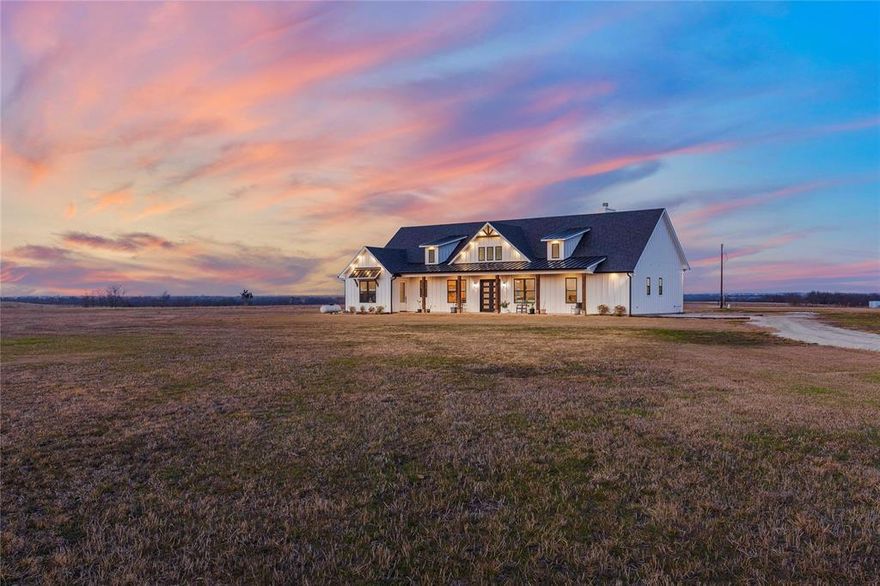 Allow your dreams to become a reality on land where the possibilities are truly endless. This 26.5 acre ag exempt property offers the rare flexibility to build multiple homes, create a family compound, or design the private retreat you’ve always envisioned. The land is unzoned and features multiple electrical services with three 200AMP breaker panels, providing ample capacity for an oversized garage, workshop, or ADU. A large aerobic septic system, private well with automatic pump system, RV septic hookup, and propane tankless water heaters provide low maintenance utilities. Escape to the perfect blend of luxury and country living with this stunning modern farmhouse, set amid sweeping hay fields and a serene, stocked pond. The board and batten exterior and expansive front porch create unforgettable curb appeal from the moment you arrive. Inside, soaring vaulted ceilings, sun filled spaces, and an impressive open layout welcome you home. With 4 spacious bedrooms and 4 beautifully designed bathrooms, there’s room for both everyday comfort and effortless entertaining. Oversized windows frame panoramic countryside views and flood the home with natural light, seamlessly connecting indoor and outdoor living. Every detail reflects rustic elegance, from warm finishes to airy, flowing spaces. Step onto the back porch to savor peaceful mornings, evenings, and uninterrupted views of your private acreage. The land is fully fenced and ideal for cattle, horses, or recreation. Productive hay fields support the ag exemption, adding long term value and tax benefits. In addition to the tranquil setting, you’re just minutes from Gainesville and I-35, with convenient access to dining, shopping, and daily essentials. Plus, you're near Lake Ray Roberts and less than an hour from Lake Texoma. Whether you’re seeking a full time residence, weekend escape, or multigenerational homestead, this property delivers a rare opportunity to live beautifully and freely under wide open Texas skies.