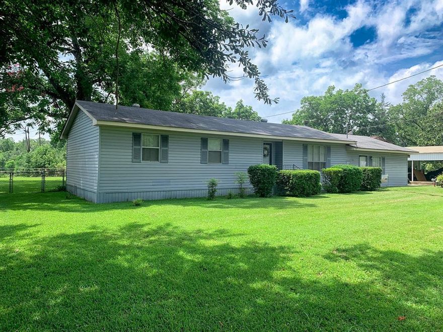 Spacious, 3 bedroom, 3 bathroom family home with over 1800 heated square feet home situalted on just under 1 acre.  2 car covered carport with small shop and place for garden.  Huge, shaded fenced back yard for family gatherings. Talk about country living! Large living room with dining room just off of the kitchen, a canning kitchen located inside the laundry room features tons of cabinets, sink, full bathroom and hook-up for stove. You also have a den with a wood burning fireplace for gathering to watch football games on Sunday. Outside is a garden area, shop, 2 car carport and tons of storage. Schedule your appointment today!