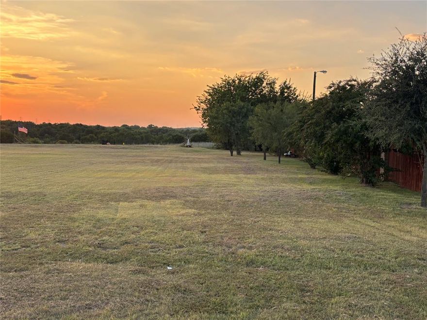 This lot is located in the highly popular Hencken Ranch Estates Community.  This lot backs up to Federal Park land -Lake Benbrook State Park, so you will the privacy and beauty of the park behind you.  Also, this lot is not in the HOA, so you would not be under the POA governance and have not have yearly assessments.  There are deed restrictions for construction that follow the same as the HOA.  This lot is a little over 3 acres with plenty of room to build a residence and a shop if wanted.  There will be a few feet on the left side of the property that will need to be surveyed off and stay with the property on that left side.  Don't let this one get away, not many lots available in this area of Tarrant County. You can truly feel in the country with the peace and quiet.  There is a survey of the lot.  In the photos there is a picture of the survey with the estimated footage to be surveyed out.