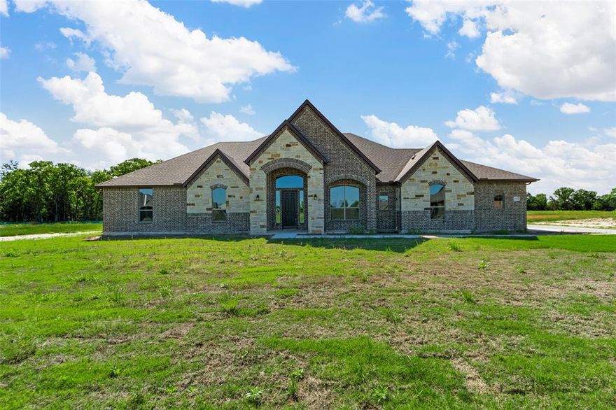 Spectacular New Construction Home built by Robbie Hale Homes in the quiet country setting of Oak Point Estates in Terrell. This home will be situated on a one acre lot. The home is 3215 sf air conditioned, 4 spacious Bedrooms, 3 Baths, a Game Room or Office, a large Covered Patio, 3 car Garage and a 30' X 40' Shop. Enter the home through the foyer with the Formal Dining Room to your right and the inviting Living Room off of the foyer. The Living Room features a Stone corner Fireplace with a Stained Mantle, awesome Wood Look Tile flooring, Crown Molding, 5.5 inch Baseboards and access to the Covered Patio. The Wood Look Tile flooring is featured throughout the home with carpet located in the bedrooms and the game room. , Quartz Countertops, a massive walk-in Pantry and Stainless Steel appliances being a Built-in Double Oven, a Built-in Microwave, a 36 inch cooktop, a 36 inch vent-a-hood, and a dishwasher. The Master bedroom is large and has access to the Covered Patio. The Master Bathroom will feature separate vanities, a jetted tub, a nice sized walk-in shower and his and hers closets. The home features a Jack and Jill secondary bathroom for two of the secondary bedrooms and a full secondary bathroom off of bedroom 4. The Game Room or Office has access to the Covered Patio. The Utility Room is big and includes plenty of Upper cabinets with a sink. The Garage is an oversized 3 Car Garage with a storage closet and the floor being epoxied. The exterior includes sod, landscaping and the sprinkler system will be full for the front and side yards with a perimeter across the back of the home. Energy efficiency will include R-38 blown in attic insulation, R-15 wall insulation, vinyl windows being dual paned windows, radiant barrier roof decking, and a high efficiency HVAC system. Builder to pay for the Title Policy, the Survey and up to $20k towards Closing Costs. High Speed Fiber is available in Oak Point Estates.