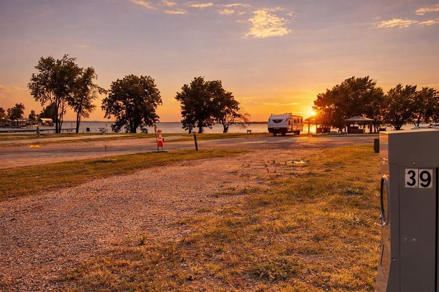 Welcome to easy, upscale RV living on the shores of Richland Chambers Lake. This interior pull-through lot is thoughtfully designed to make getting your RV in and out simple and stress-free, whether you’re arriving for the weekend or settling in for a longer stay. With water, sewer, and electric hookups right at the lot, setup is quick and convenient so you can start enjoying your time right away.

You’ll love the scenery here, with lake views on the front side of the lot and peaceful pond views behind you, giving you the best of both worlds. Morning coffee comes with a glimpse of the lake, while evenings feel calm and private as you look out over the water and watch the wildlife.

The lot is located in a luxury, gated RV community known for its beautifully maintained grounds and paved roads. Manned and gated access provides added security, and the amenities are truly impressive. Enjoy boat storage, a boat ramp, and a community pier for easy lake access, along with an open-air clubhouse featuring laundry and grill facilities that’s perfect for socializing. There’s also a lakefront swimming pool, a dog potty area, and a playground, making this community welcoming for everyone.

Whether you’re looking for a relaxing getaway or a comfortable home base by the lake, this RV lot offers a rare combination of convenience, views, and resort-style amenities in a stunning lakeside setting.