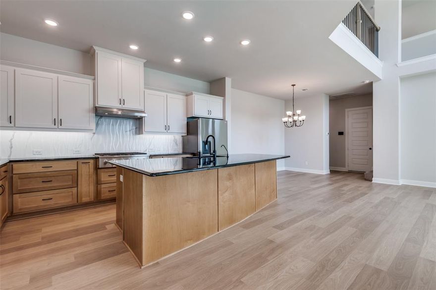 This beautifully designed 2023 David Weekley home features a double-story main living area open to a fantastic two-toned Black Glama island kitchen. The kitchen has a 6-burner GE Cafe gas cooktop, a convection oven, and a large walk-in pantry, providing ample storage with pot drawers, pull-out features, and a gorgeous modern backsplash. Furnished with a modern washer, dryer, and refrigerator, other convenient amenities include a mudroom with built-in storage just off the garage entry, as well as a huge storage closet located under the stairs. Storage has been maximized throughout the home, featuring plenty of closet space, including dual walk-in closets in the primary suite. Upstairs, there is a second living area loft that separates the primary bedroom suite from the spare bedrooms, ensuring privacy for everyone. The laundry room is conveniently located on the second floor alongside the primary and two spare bedrooms. A first-floor bedroom, which is adjacent to a full bath, can serve as an office or study for those working from home. Designed for modern efficiency, 1502 Fennel is built with a tankless water heater, has LED lighting throughout, and features Energy Star® rated appliances for energy savings year-round. The Harvest Community by Hillwood offers a variety of amenities, including parks, pools, lakes, and hike-and-bike trails, ensuring that your free time is filled with enjoyable activities. Pet lovers are welcome, as you can bring one furry friend that weighs under 20 lbs on a case-by-case basis with an additional security deposit.