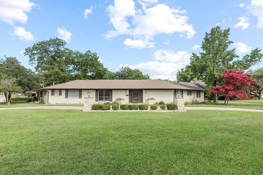 Discover this breathtaking mid-century modern home nestled on a peaceful .65 acre corner creek lot in the heart of McKinney. Gorgeous, recently installed (2025) hardwood floors invite you inside this entertainers dream home designed with both style and functionality. An expansive living room showcases beautiful Terrazzo floors, wood-beamed ceilings and cozy gas starting fireplace with marble surround. Make your way into the charming kitchen equipped with sleek stainless steel appliances, dual ovens, island with copper vent hood, an abundance of counter-top space for prep and a breakfast room with a built-in hutch. A second living space or game room is perfect for entertaining guests and features a built-in bar and access to a full updated bath. Escape after a long day to the serene primary bedroom with a modern updated bath with separate vanities, Bosch towel warming drawer, and dual showerheads. All bedrooms have walk-in closets with custom closet systems. Two well-appointed secondary bedrooms share a Jack & Jill bath with dual sinks. Relax and unwind outdoors in your tranquil backyard complete with a covered and open deck, built-in electric grill and plenty of mature trees that provide shade. Additional updates include 2 HWH - March 2025, New Gutters - 2024, 1 New AC Unit - 2021, New Coil in other AC Unit 2021. Don't miss this incredible home!