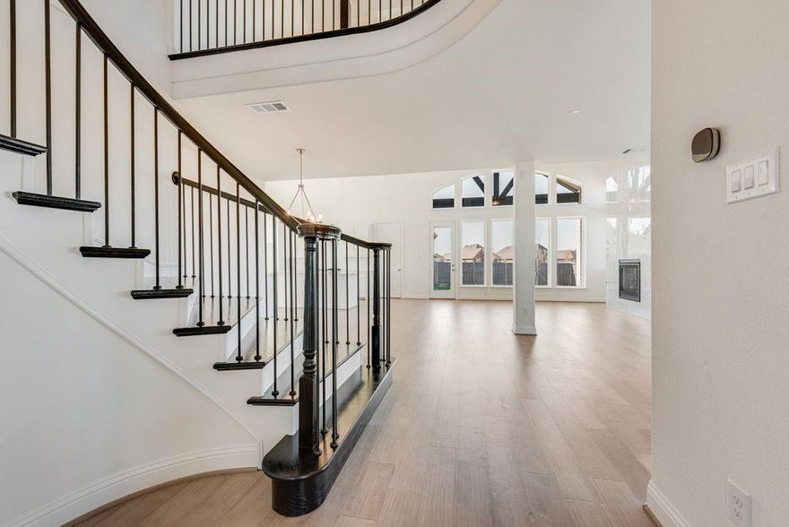 New Grand Home in super fun Prairie Ridge with neighborhood pool, miles of trails, spectacular playground & parks! JUST Completed - walk to trail system, parks & Pool. East facing homesite. Modern finishes with full oak staircase w wrought iron spindles, wood floors, 8 ft doors, rocker switches & thick door casing & trim. Vaulted family room has 2 story tiled fireplace that is open to covered back patio ready to entertain. Downstairs Media Room or Den wired for surround sound & flat screen TV. Downstairs Guest Bedroom or a Private Home Office. Upstairs gameroom for the kids with 3 additional bedrooms. Large Chef's kitchen has granite slab tops, white Shaker cabinets, stainless steel appliances, gas cooktop, full bowl sink & island for family get togethers. Primary Bath has a free standing garden tub, separate his & her vanities w rectangle sinks & glass enclosed tiled shower. Security & Sprinkler systems. Energy Star Partner features include radiant barrier roof decking & R38 ceiling insulation for low energy bills!