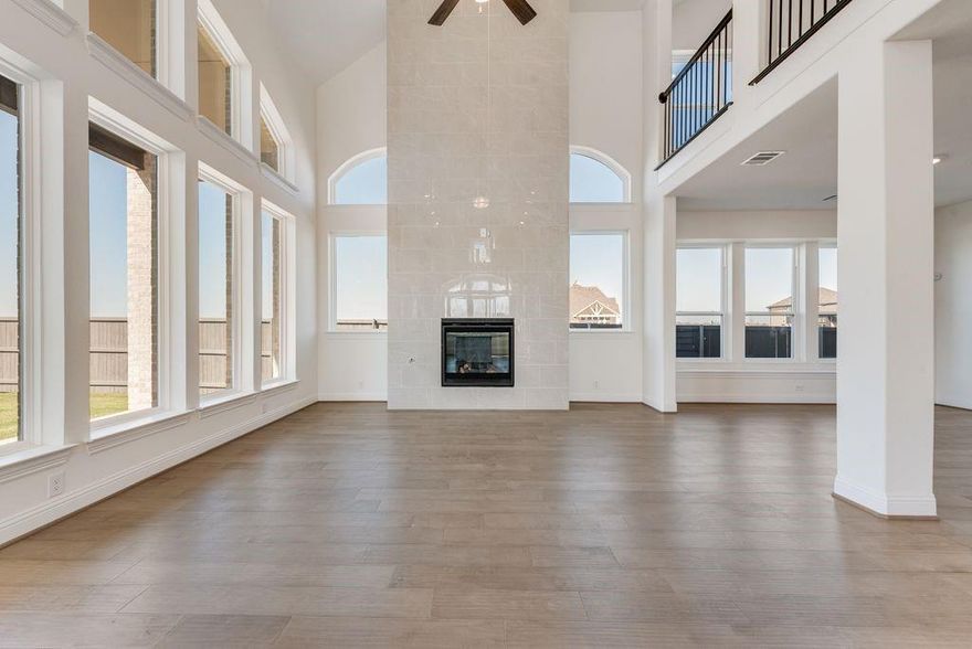 New Grand Home in super fun Prairie Ridge with neighborhood pool, miles of trails, spectacular playground & parks! JUST Completed - walk to trail system, parks & Pool. East facing homesite. Modern finishes with full oak staircase w wrought iron spindles, wood floors, 8 ft doors, rocker switches & thick door casing & trim. Vaulted family room has 2 story tiled fireplace that is open to covered back patio ready to entertain. Downstairs Media Room or Den wired for surround sound & flat screen TV. Downstairs Guest Bedroom or a Private Home Office. Upstairs gameroom for the kids with 3 additional bedrooms. Large Chef's kitchen has granite slab tops, white Shaker cabinets, stainless steel appliances, gas cooktop, full bowl sink & island for family get togethers. Primary Bath has a free standing garden tub, separate his & her vanities w rectangle sinks & glass enclosed tiled shower. Security & Sprinkler systems. Energy Star Partner features include radiant barrier roof decking & R38 ceiling insulation for low energy bills!