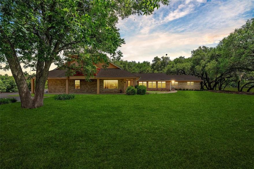 Experience the ultimate ranch lifestyle just minutes from town in this spectacular 5,278 sq ft estate on 16+ acres in Midway ISD. Designed for those who crave space, privacy, and versatility, this property offers the rare blend of luxury living and country functionality. Whether you’re raising animals, entertaining guests, or simply enjoying wide-open views, this home delivers it all.

Inside, you’ll find 4 spacious bedrooms—including two master suites—and 5 full bathrooms, offering flexible accommodations for multigenerational living or long-term guests. The home boasts three living areas (two downstairs, one upstairs), a movie room, formal dining, a dedicated office, unbelievable storage, and a cozy fireplace that anchors the main living space. The large, chef’s kitchen overlooks a serene landscape of cornfields and pastures—perfect for morning coffee or evening gatherings.

Outdoors, the amenities are truly exceptional. A massive barn with a concrete floor, roll-up door, workshop, full bathroom, and kitchenette offers endless possibilities—including guest quarters or a hobby space. A separate workshop houses your private Artesian water well system and provides space to tinker or store equipment. Additional outbuildings include a tool shed, a chicken coop, a working corral, and a high-functioning greenhouse complete with water, electricity, a fan, and a sustainable aquaponic system that uses fish to nourish plants.

The home sits behind a gated entrance and down a wide, tree-lined drive with irrigation. The lush St. Augustine grass, mature trees, and a beautifully manicured courtyard with stone walkways and ornamental plants make the backyard a dream for relaxing or entertaining. Parking is abundant with a 3-car extra-deep oversized garage, detached carport, and paved spaces for guests. 

This is more than a home—it’s a private retreat built for the ranch lifestyle you’ve always dreamed of.