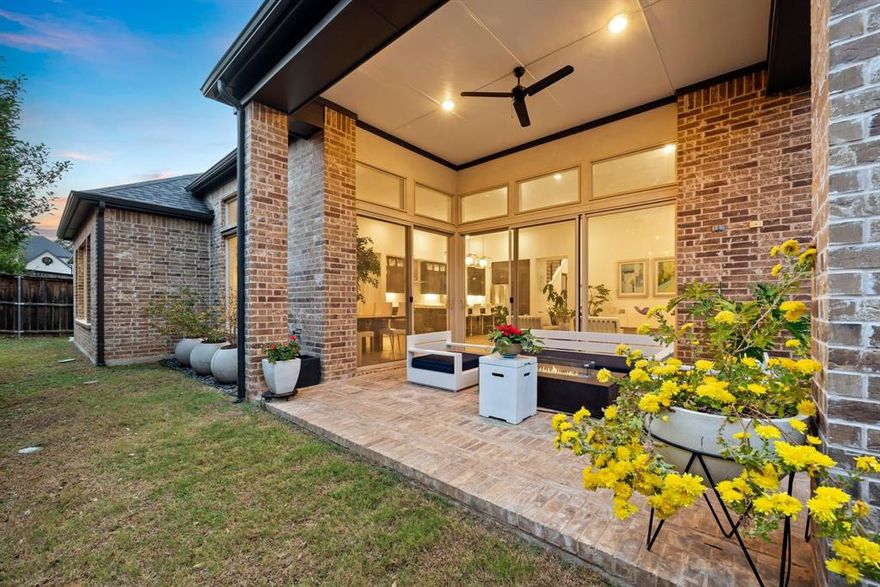 Don’t miss this stunning, move-in-ready showpiece in a coveted gated community within Grapevine-Colleyville ISD. This unique 1.5-story home blends modern luxury with thoughtful craftsmanship, highlighted by floor-to-ceiling windows and mirrors that fill the open living room with natural light. Custom decorative wainscoting frames the cozy fireplace, creating an elegant focal point. The gourmet kitchen is built for entertaining, offering quartz countertops, European frameless cabinetry with satin nickel hardware, an oversized quartz island, and premium Electrolux stainless appliances. Just off the foyer is a private study ideal for working from home, along with two spacious secondary bedrooms on the main floor. The primary suite feels like a retreat, featuring a sleek Baja shower with a frameless glass panel and a generous walk-in closet that connects to a grand utility room complete with custom cabinetry and a sink. Upstairs, a versatile game room awaits with a wet bar, prep sink, and beverage cooler, plus a dedicated media room and an additional powder room, perfect for hosting or unwinding. Two wall-height sliding glass doors lead to the signature covered patio, offering seamless indoor-outdoor living for relaxed evenings or gatherings. A three-car garage, including a single bay with custom cabinetry, adds extra convenience. Additional luxury touches include designer pendant lighting, frosted glass doors, LED cabinet lighting, extended custom stair railing, and an audio-visual pre-wire package. With its modern style, abundant natural light, premium finishes, and award-winning schools, this home brings the upscale lifestyle buyers are searching for.