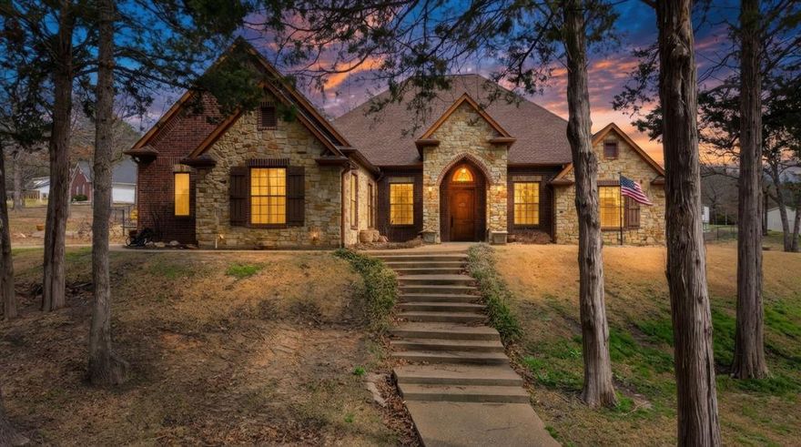 Step into luxury living on the edge of picturesque Mineola in this custom-built home located within Hickory Creek Estates.

Situated on a spacious 1-acre lot, this 3-bedroom, 3.5-bath residence also features a versatile media-flex room and thoughtful design throughout. Upon entering, arched column walls frame the soaring ceilings and detailed layered trim work. Solid surface flooring carries seamlessly through the open-concept layout, creating a clean and cohesive flow.

The gourmet kitchen is designed for both everyday living and entertaining, featuring a Hallman dual fuel gas oven, granite countertops, pot filler, dual pantries, oversized island, farm sink, and breakfast bar.

The home offers two primary suites, each complete with private office space, washer and dryer hookups, and well-appointed en suite bathrooms. The main primary suite includes an expansive walk-in double shower. Jetted Tub, and the closet is massive at 14X12, with built in dressers.  The door in the closet came from France. 2 Laundry rooms
Outdoor living is equally impressive with a heated saltwater pool and cascading waterfall. The large covered patio and cabana provide excellent space for relaxing or hosting gatherings. Mature shade trees enhance the setting, and there is plenty of room for gardens, recreation, or future plans.

Additional features include a whole-house 22kW generator and a built-in insect misting system for added comfort and convenience. A separate slab foundation with plumbing already in place offers the opportunity to build a 24x30 shop or pool house.

Recent updates include roof replacement in 2021, Hallman oven in 2021, Bosch dishwasher in 2021, pool sand filter and saltwater converter in summer 2022, pool heater in January 2024, and both downstairs HVAC systems replaced in summer 2023. Pool pump and motor new 2025.

This exceptional property combines quality construction, practical upgrades, and refined comfort in one of Mineola’s desirable neighborhoods.