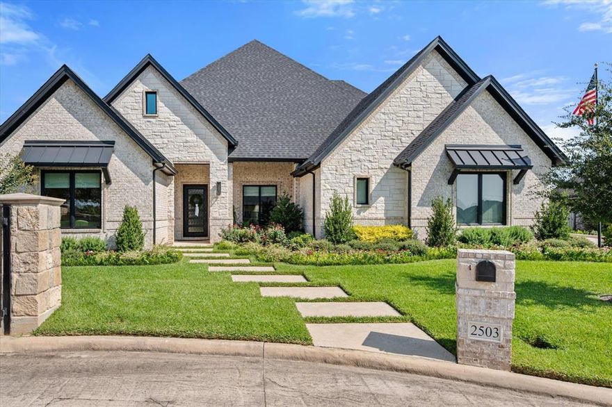 Stunning designer-styled home on over a half acre This home features 4 bedrooms, 3 full size baths with an open concept layout and exceptional details throughout. The gourmet kitchen is a chef’s dream with an oversized built-in refrigerator, ceiling height cabinets with lighting, abundant counter space, and seamless flow into the dining room and great room. Vaulted ceilings with beams, rich wood floors, designer lighting and a stone fireplace with gas logs create an inviting centerpiece. A private study, secondary living room, and split bedroom floorplan provide flexibility and function.The luxurious primary suite features a soaking tub, walk-in shower with 3 shower heads, dual vanities, and a custom closet with direct access to the laundry room. Secondary bedrooms are thoughtfully positioned for privacy and comfort. Step outside to a resort-style backyard designed for entertaining year-round. The expansive full-size covered, outdoor living area perfect for relaxing and includes a dining area large enough for a table of 12. There are remote controlled screens that fully enclose the space. The sparkling pool with waterfall features is framed by decorative pavers and artificial turf. For the backyard chef there is a full size outdoor kitchen with built-in grill and cooking equipment. A greenhouse and raised garden beds complete the backyard retreat. Additional highlights include a epoxied floored 3-car split garage with built-in storage, plus a full-size staircase leading to a large attic with an enormous amount of storage for all your holiday decoration. The house has upgraded spray foam throughout the walls of home and attic to make it energy efficient throughout the year. This home offers the perfect blend of style, comfort, and total indoor-outdoor living and is situated in a small gated community with easy access to highways for commuting and shopping.