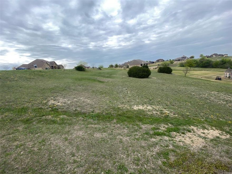 RARE FIND! This hilltop lot is one of the few lots left to build in the beautiful Canyon West gated golf course community in BROCK ISD. This is an amazing hilltop lot overlooking the course and Club House. Neighborhood allows septic & water wells, reducing your monthly expenses. Bring your own builder! HOA fees include biweekly trash service. Canyon West Golf Club is an award-winning Par 72 golf course that winds through the roaming foothills of Parker County.
