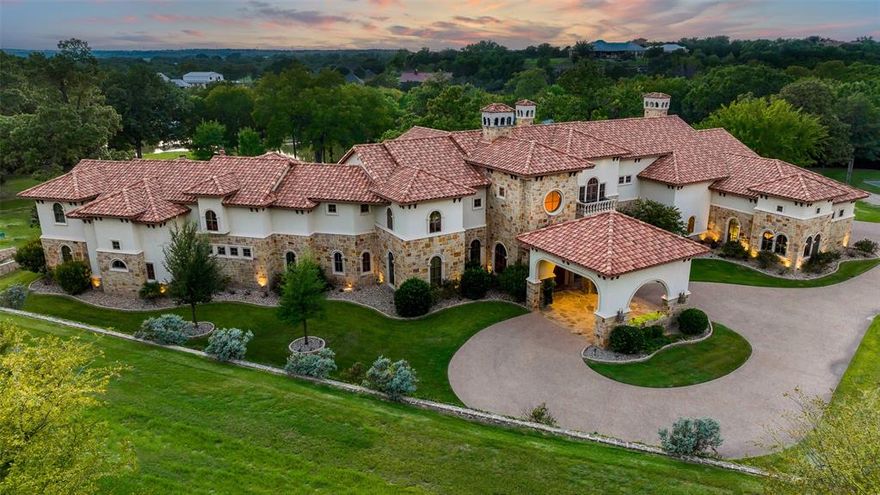 There are truly no elegant words that will prepare Buyers for the luxurious recreational and residential experience featured in this endless oasis of fun. In the gated development of Silverado on the Brazos this one of a kind beauty sits neatly tucked at the end of a discrete cul de sac. Property owners can conveniently jump into their boats and get to waterfront restaurants and entertainment at nearby Lake Granbury within minutes. There’s also room for horse enthusiasts to build a barn and riding facilities. The main 6BR custom home is the centerpiece of the 13.733 acre estate which features large pool with infinity edge, water fall, slide, swim up bar, and extensive decorative lighting. A quaint guest home sits in the back yard space around amenities which include lighted basketball court, volleyball beach, zip line, covered boat slip, boat dock, outdoor shower, multiple fire pits, and much more!!!…  If entertaining guests is a necessity, this place can not be beat!!