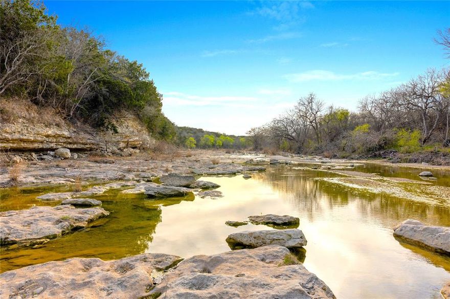 127.21 WATERFRONT ACRES  *Ranches at the River*  A rare opportunity to own one of the most desirable properties in Central Texas. This breathtaking tract offers over approximately 1,700 ft. of Middle Bosque River frontage, approximately 1,200 ft. of Pecan Creek frontage, almost  1,000 ft. of New Windsor paved road frontage. Featuring gorgeous rolling pastures, mature hardwoods, nearly 100 feet of elevation change and panoramic views that stretch for miles. With bluffs, fertile grazing pastures, and walk-in access to the Middle Bosque River, it's perfect for your dream home, working ranch or private retreat. The sellers have constructed a concrete bridge over Pecan Creek, providing full access to the entire property, all the way to the river. A beautiful mix of pasture, woods, a tank and waterfront making this land ideal for cattle, horses, ATVs, hunting, fishing, kayaking, camping. Nice woods for wildlife coverage and habitat...good amount of deer. Light restrictions protect the property's natural beauty and privacy, including no mobile or modular homes (barndominiums are welcome). Ag exemption in place, WATER METER and electricity available. Premier Central Texas location, convenient to Highway 6, Highway 84, Speegleville Road and FM 317 (Lone Star Parkway) and just 1520 minutes from Waco. Central Bosque Water, Heart of Texas Electric and McGregor ISD. Ag Exempt. McGregor and Crawford area.