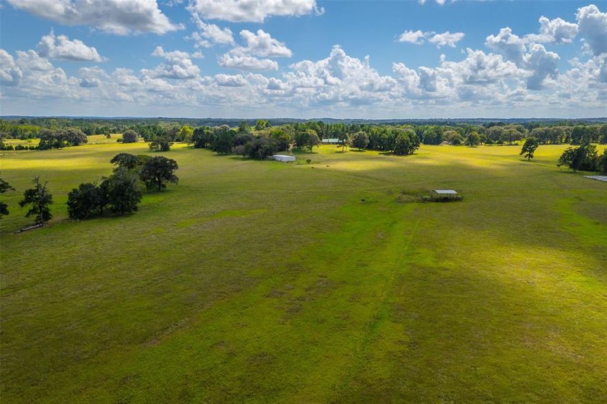 Welcome to an outstanding East Texas opportunity: 155.924 ± ac in Anderson County, located at 905 ACR 358, just north of Palestine. This tract strikes a rare balance between productive improved pasture, managed timber, and scenic topography—making it ideal for cattle operations, acreage living, and recreational enjoyment alike.
The property is predominantly open and improved pasture, with large, well-scattered hardwoods and pines that lend shade, structure, and visual appeal across the landscape. The terrain is rolling, with elevations ranging from approximately 370' up to 480' ASL, creating diverse grazing zones, drainage patterns, and excellent vantage points.
Frontage along ACR 358 runs the full length of the southern boundary, ensuring good access. The land slopes generally downhill to the north, so the home (located near the higher elevations adjacent to the road) looks out over the tract, offering long views to the north from the rear patio. The extreme northern end transitions into denser timber and ultimately slopes toward a creek or drainage, giving a touch of bottomland character and habitat diversity.
From a livestock and operational perspective, this property is well designed for efficient, rotational grazing systems. Strong perimeter and cross fencing are already in place along with a central hub of covered working pens.
The property is improved with a 1,965 sf home with an oversized two car garage. Access is via a custom gravel drive.  The property also has a 36' X 72' pipe frame barn that is sheeted on two sides with about half the floor area concreted.  It includes an enclosed storage-tack area and pipe horse stalls that open into a small paddock, complete with a horse walker.  Adjacent to the home is also a small greenhouse for personal gardening or plant propagation.
Contact us today to schedule your private tour and experience firsthand the sweeping views, the functional infrastructure, and the promise of life on this East Texas acreage.