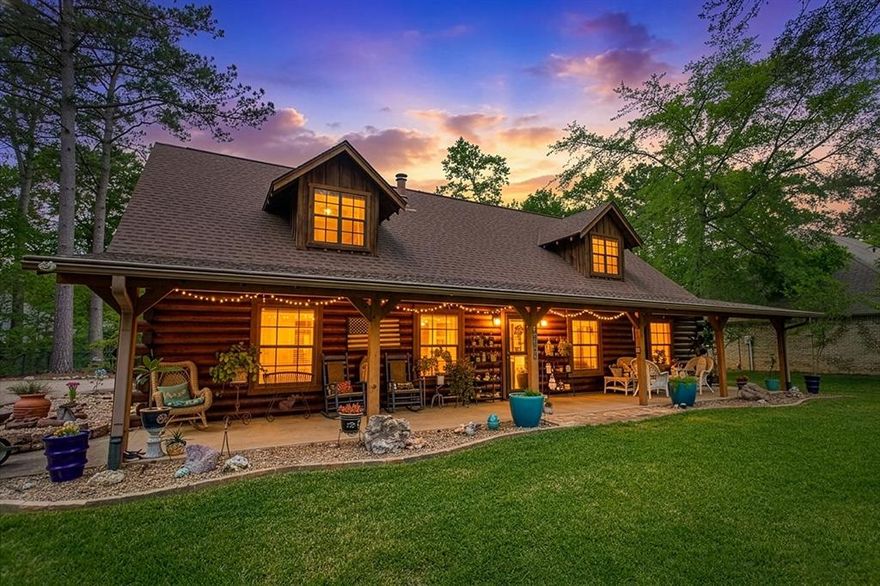 This stunning Satterwhite log home offers 2,550 square feet of timeless character and inviting comfort. Designed as a 1.5-story residence, the home features 4 bedrooms and 3 full bathrooms, blending rustic charm with thoughtful functionality. A full-length covered front porch welcomes you and provides an ideal space to relax and take in the peaceful surroundings. Inside, wood flooring and a dramatic vaulted beaded-board ceiling create an immediate sense of warmth and craftsmanship. The spacious living area is anchored by a cozy wood-burning stove and enhanced with built-in bookshelves, making it perfect for both entertaining and everyday living. The kitchen is well-appointed with a custom island, abundant cabinetry, and an adjoining dining area designed for gatherings. The main level includes a generously sized laundry room, ample storage throughout, and a large primary suite for convenient single-level living. The primary bathroom features dual vanities, a walk-in closet, and a dedicated dressing area. A second bedroom or study and a full bathroom complete the downstairs layout. Upstairs, two additional bedrooms are joined by a versatile game room or bonus space, offering flexibility for guests, hobbies, or recreation. The upstairs full bathroom provides extensive storage to keep everything organized. Outside, the fenced backyard is beautifully landscaped and complements the natural appeal of the log construction. An attached carport offers substantial attic storage, while additional amenities include a full yard sprinkler system, rain gutters, a circular driveway, and a separate storage shed. This exceptional home combines classic log-home charm with modern convenience in a truly inviting setting. Hideaway residents enjoy a resort-style living with amenities including security, 3 scenic lakes, 27-hole golf course, tennis and pickleball courts, an Olympic-sized pool, multiply parks, nature trails, a beach area, and a dog park. Hideaway is in Lindale ISD.