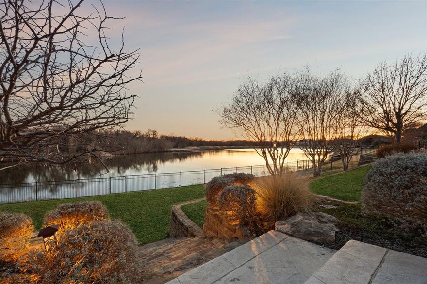 Welcome Home to this STUNNING, Waterfront, Updated Custom home in coveted Timarron. Built with exquisite craftsmanship by Cary Hy Custom Homes, this one-of-a kind estate sits on the prettiest and most serene lot in Timarron! Awake each morning to lovely sunrise, the birds splashing in the lake, the private tree view and virtually no sense that there are neighbors nearby. The owners have upgraded all spaces to create a open plan, using Ralph Lauren inspired design. This family & entertaining-friendly home boasts the highest level of designer finishes. Designed to enjoy tranquil lake views from all the primary rooms, spectacular lake and golf course vistas beyond span the entire rear of the home. Extensively updated, the Chef’s Kitchen was thoughtfully reimagined with a second island, Sub-Zero refrigerator-freezer, leathered quartzite countertops, Wolf gas range, Wolf steam oven, microwave, warming drawer, smart working sinks, and Bosch dishwasher. The Posh Butler's Pantry features a full-size, double EuroCave wine preservation system. Step away to the private Primary Suite to enjoy spectacular water views, a sitting area with soaring fireplace plus a beautifully updated Spa-inspired Bath. All Bedrooms feature updated private baths and walk-in closets. The upstairs also features a spacious Game Room with full Wet Bar and balcony overlooking the lake and golf course, plus a separate Media Room. Step outside to your Private Oasis featuring a bubbling pool with attached spa, expansive outdoor covered living area with stone fireplace, and a fully-equipped Outdoor Kitchen complete with Sub-Zero refrigerator, Lynx grill & built-in Big Green Egg. Tucked away you find a private downstairs Bonus room with separate entrance, ready to become your perfect studio, executive office, wellness space or fitness retreat, all framed by breathtaking views. The views are incredible, the setting is very serene and the pool area is private... all on one of Timarron’s best settings!