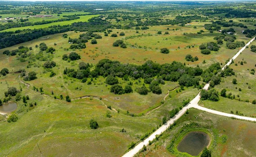 This 77.07-acre property offers a great mix of usability and natural beauty, featuring rolling terrain, scenic elevation changes, and a picturesque pond. With no known restrictions and an ag exemption already in place, the possibilities are wide open—run cattle, raise horses, enjoy hunting, or build your dream home. A seasonal creek adds to the natural charm, while scattered live oak trees provide shade and enhance the landscape. Electricity is available, making it easier to bring your vision to life. The land is covered in coastal Bermuda and native grasses with a desirable mix of clay and sandy loam soils, ideal for grazing and long-term use. A rare opportunity to own a well-rounded piece of Texas land with both water features and utilities in place.