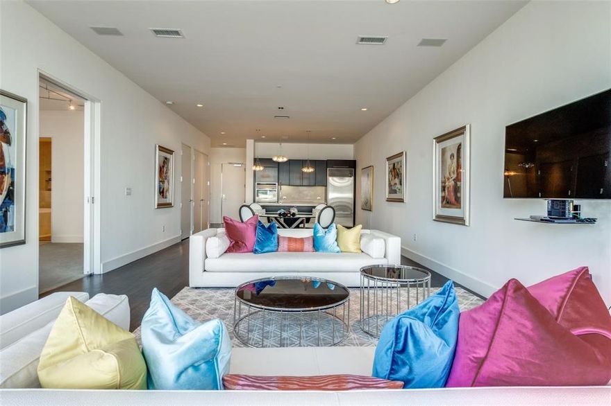 The House is a luxury high-rise in Victory Park designed by Philippe Starck, featuring stunning modern interiors and high-end finishes. Located on the seventh floor, this residence boasts floor-to-ceiling windows that offer serene views of Victory Park’s green space and fountain, with a wrap-around view extending to Downtown Dallas.

The kitchen is sleek and sophisticated, equipped with Crema Marfil marble countertops and backsplash, complemented by premium appliances from Sub-Zero, Wolf, and Asko. The bathroom continues the luxurious marble theme, featuring a double vanity, extra-large soaking tub, and a separate shower. Dark-stained white oak hardwood floors, museum-finish walls, and contemporary lighting add to the residence’s refined aesthetic. A flexible second living area can serve as a den, study, or office. 

Building amenities include a pool terrace with a 130-foot infinity saline pool, a separate spa, a grilling and outdoor dining area, an owners’ lounge with a coffee bar, a guest suite, and a fully-equipped gym. Residents also enjoy concierge services, valet, package delivery, 24-hour security, and one reserved parking space.