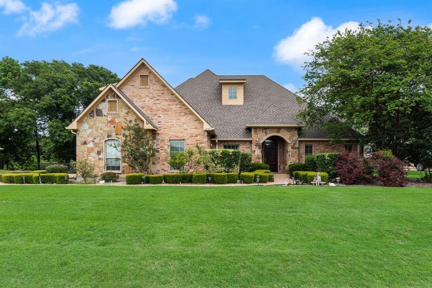 Welcome to lake living in The Shores on Richland Chambers Lake, where Hill Country charm meets comfort and functionality. Situated on a .523-acre canal-front lot with water views, this 5-bedroom, 3.5-bath home offers over 3,000 sq ft of inviting, open-concept living designed for relaxing weekends and effortless entertaining.

Inside, you’ll find warm wood flooring, arched walkways, crown molding, and a light-filled living area with custom built-ins and backyard views. The kitchen is designed for gathering with granite countertops, a large island, walk-in pantry, breakfast bar, and a beverage station with wine fridge. A private office with French doors and multiple dining areas add flexibility.

The spacious primary suite features a soaking tub, separate walk-in shower with body sprays, dual vanities, and generous storage. Additional bedrooms include a Jack-and-Jill layout, ideal for family or guests.

Outdoors, enjoy peaceful mornings, sunset evenings, and easy access to the water with a covered patio, fire pit, and mosquito misting system. The property includes a private boathouse with lift, plus Boat Slip #19 in The Shores marina—giving you the best of both worlds with private dock access and quick entry to open water.

A detached structure adds versatility with a 625 sq ft workshop below and a 450 sq ft efficiency guest apartment above, complete with kitchenette—perfect for guests, extended stays, or potential income.

Additional features include a whole-home water filtration system and tankless water heater. Located in a gated community with marina, pool, clubhouse, fitness center, and more—this property is your gateway to enjoying the best of Richland Chambers Lake.