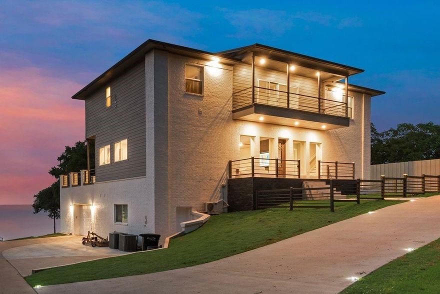 This Stunning, Modern Lakefront Home located in a premiere location on Richland Chambers Lake is the Epitome of Luxury! The first two floors are built with insulated concrete form (ICF) construction, it offers unparalleled energy efficiency and durability. The home has a basement with 13 ft ceilings, half-bath and massive workshop-perfect for storage and hobbies. An elevator serves all three floors, making access easy and convenient. The expansive primary suite has unparalleled views to wake up to & features a book match design porcelain wall & flooring in the bath, and the walk-in closet has a private laundry room. The mother-in law suite is loaded with a kitchenette, laundry room & ensuite bath! Step outside onto the terrace with turf grass and enjoy wide open views of the lake! Facing west for beautiful sunsets, this is the perfect spot to unwind after a long day. The boathouse, complete with boat lift & lounging area provides you with endless opportunities to enjoy the lake.