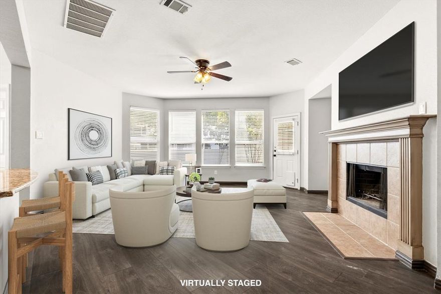 Welcome to this expansive, energy-efficient two-story home located in the master-planned community of Providence Village. A charming front porch sets the tone as you enter into a thoughtfully designed home spanning 2,600 square feet of living space. Inside, you’re greeted by wood-look laminate flooring, soaring 19-foot ceilings, and a formal dining area that flows seamlessly into the heart of the home.
The open-concept layout is ideal for entertaining, featuring an expansive living room with a cozy wood-burning fireplace and uninterrupted sight-lines into the kitchen and breakfast area—perfect for hosting gatherings both large and small. The kitchen is well-equipped for entertaining and everyday living, offering generous prep space with granite countertops, stainless steel appliances, a convection oven, island, and a butler’s pantry for added storage and convenience. Designed with comfort and efficiency in mind, this home includes 18 SEER AC units, added attic insulation, and smart home features such as a Ring doorbell and smart thermostats—helping you stay connected while maximizing energy savings. A full sprinkler system adds convenience for maintaining the outdoor space year-round. The first-floor primary suite provides a private retreat with an ensuite bath complete with dual sinks, a garden tub, separate shower, and a walk-in closet. Upstairs, the home truly shines as an entertainer’s space with a large game room and an oversized media room, ideal for movie nights, game days, or relaxing with family and friends. Three additional bedrooms and a full bath complete the second level, including one bedroom with access to a private balcony. Residents of Providence Village enjoy access to a variety of community amenities, including a resort-style pool, clubhouse with fitness center, scenic lake, fishing, walking trails, and more.