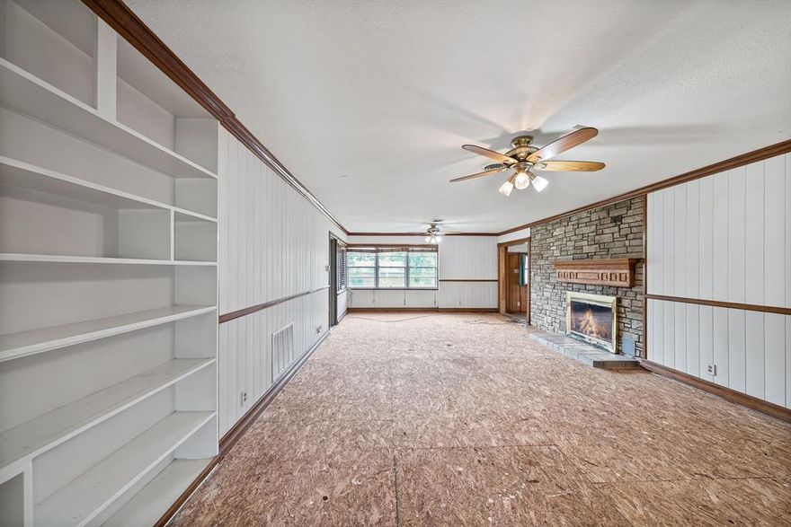 Seller willing to put in flooring to help with VA and FHA lending with an additional 10K in sales price!!! Priced aggressively in an as-Is condition with a brand new 30 year composition roof installed in the last quarter of 2024! Let your imagination run free in this home on over a half an acre in a beautiful neighborhood. This home boasts a phenomenal floorplan with two primary suites, a third bedroom which could easily double as an office with built in shelving and a desk. Two large living areas, each with its own special character.  It has a formal dining area, two fireplaces, a sun room, a large utility room, a large bonus room for storage or a possible mud room, a garden area, a storage shed that could be a man cave or she shed, a workshop, and a privately fenced in back yard. Talk about potential! With a little handyman work this expansive house could be an absolute dream home!