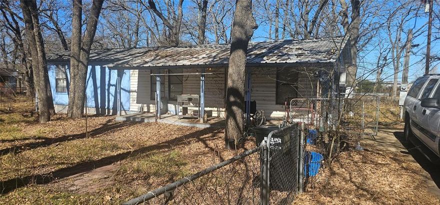 Older single family home on extra large lot.  Yard is fenced surrounding home. Home needs TLC but would make a great weekend Lake cabin or tear down existing home and build new on large lot. Lot being extra large could possibly place multiple homes on lot. Would need to contact city for building restrictions. All appliances remaining with home.  All information is approximate, buyer and buyer's agents to verify all information.