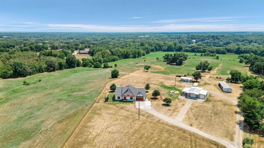 Live the best of both worlds! Welcome to country living with the convenience of being only minutes away from all that Downtown Denison offers & Texoma Medical Center. This stunning modern farmhouse-style home is situated on 50.76 acres of picturesque land. It was recently rebuilt from slab up, so it is a new home!  As you step inside, you'll be greeted by an open floor plan that blends modern design with rustic charm. The heart of this home is the beautiful white kitchen, complete with natural granite countertops. Outside, the stables and tack room make this is a dream come true for horse enthusiasts. Additionally, there is a workshop, guest house, & covered RV or boat parking. Ag exemption already in place. Just an hour north of Dallas & minutes from Lake Texoma & Choctaw Casino. Don't miss out on the opportunity to make this your own slice of paradise.