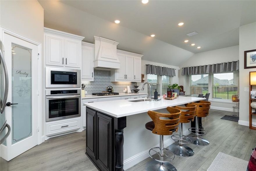 THIS ONE IS PRICED TO SELL! Why wait to build when you can move into this nearly new, one-story home that’s only a year old? Built in November 2024, this beautifully maintained 3-bedroom, 2.5-bathroom home with a dedicated study offers all the modern amenities of new construction—at a savings of nearly $50K compared to similar new builds. Plus, the builder’s warranties will transfer to the new owner! Inside, enjoy durable luxury vinyl plank flooring throughout the main living areas, with cozy carpet in the bedrooms. The open-concept kitchen is a showstopper, featuring quartz countertops, an oversized island, stainless steel appliances, gas cooktop with vented hood encased in custom cabinetry, and a walk-in pantry. The spacious living room is anchored by a stunning floor-to-ceiling stacked stone gas fireplace. The oversized primary suite offers space for a sitting area, desk, or workout zone. The ensuite bath includes dual vanities with granite countertops, a garden tub, a separate ceramic-tiled shower, walk-in closet, and a linen closet. The two secondary bedrooms are split from the primary for privacy, with a full bath between them. Additional features include a large utility room with built-in mudroom area, powder bathroom for guests, full gutters, tankless water heater, and an oversized 2.5-car garage with approx. 100 sq ft of extra storage and a cedar-clad garage door. The backyard features an iron fence with views of a greenbelt and walking trail. Located in a new master-planned community with a pool, amenity center, park, playground, greenbelts, and trails—plus zoned to highly rated Joshua ISD schools. This home truly has it all!