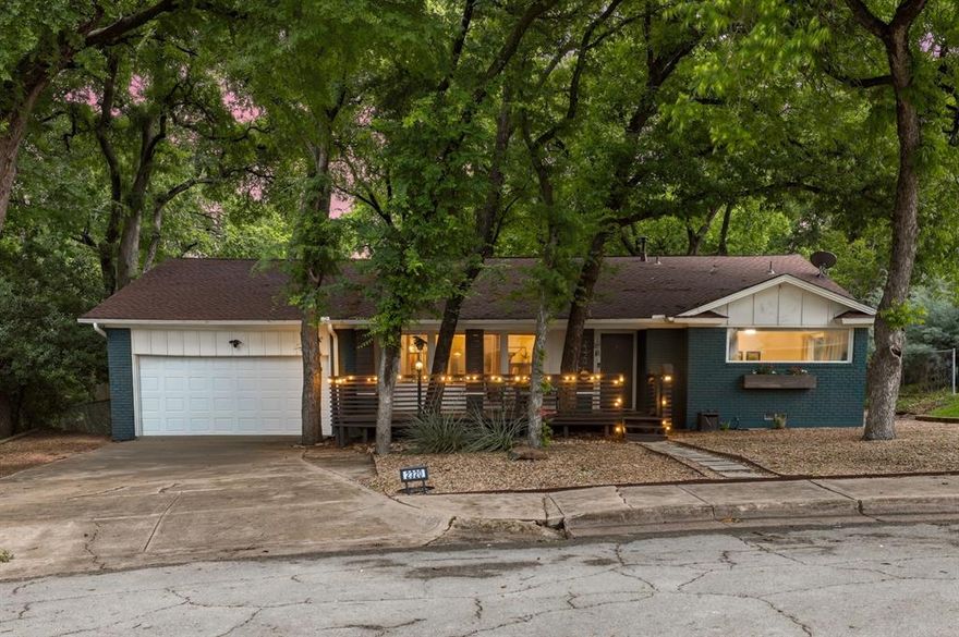 Step into your own private retreat with this entertainer’s dream home, located on an expansive, tree-filled lot in East Dallas' sought-after Hillridge neighborhood. 
The backyard is nothing short of magical. Imagine hosting unforgettable gatherings surrounded by party lights and built-in speakers that set the perfect mood. Follow the charming stone walkway to a custom fire pit and landing—ideal for cozying up on crisp evenings under the stars.
Inside, the open-concept layout is designed for effortless living. The kitchen, with its inviting breakfast bar, farmhouse sink, and wood countertops, offers stunning views of the lush backyard. The dining area flows seamlessly into the living room, where French doors open wide to bring the outdoors in. A brick wood-burning fireplace and gorgeous hickory floors add warmth throughout, while natural light floods every spacious room.
The primary suite is your personal escape, complete with custom wood paneling and a spa-like bath featuring a walk-in closet, soaking tub, and separate standing shower. Both bathrooms have been beautifully updated, and plans to expand to a three-bedroom layout are included and ready to convey with the home.
All of this in an unbeatable location—just a short walk or bike ride to White Rock Lake, perfect for outdoor enthusiasts. 
Sitting on a rare 80x205 lot, this is one of the best properties East Dallas has to offer. Whether you’re relaxing, entertaining, or planning your dream expansion, this home and backyard paradise is calling your name!