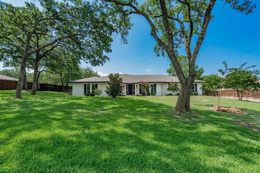 Your Own Private Oasis! Escape the hustle and bustle of city life and retreat to this serene 0.903-acre lot. Just minutes from DFW Airport, yet it feels like you're miles away.

This exceptional home offers a fabulous, flowing floor plan with flexible living spaces to suit your lifestyle. You'll love the abundance of windows that frame stunning views of the expansive, park-like backyard filled with mature trees. The bright, open kitchen seamlessly connects to the family room and outdoor space — perfect for everyday living and entertaining.

The home offers ample-sized rooms, including a versatile fourth bedroom with full bath access — ideal for multigenerational living, guest suite, or a third living area. The front room with elegant French doors provides even more options: a private office, playroom, or additional living space.

Other highlights include:
-Unbelievable storage throughout
-Large garage with AC and a half bath — ideal for hobbies or workshop
-Overflow parking for guests or additional vehicles

This home is MOVE-IN READY — a perfect home for relaxed, quiet living with space to sit back and breathe... DONT FOGET TO VIEW the list of recent updates!