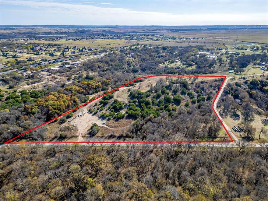 Welcome to an extraordinary opportunity in southwestern Tarrant County—a rare 11.25+or- acre property that offers one of the most breathtaking settings in the region. Ideally positioned just 20 minutes from downtown Fort Worth and mere minutes from the Chisholm Trail Parkway, this exceptional property combines exceptional convenience with truly spectacular natural beauty. Perched majestically atop one of the area's highest promontories, this prime homesite boasts absolutely stunning 270-degree panoramic views that absolutely set it apart. Gaze across a sweeping landscape, capturing mesmerizing vistas of downtown Fort Worth's glittering skyline and the serene waters of Benbrook Lake. The breathtaking views create an ever-changing masterpiece throughout the day. During the 4th of July, countless fireworks shows across Tarrant, Johnson, and Parker Counties can be seen. This canvas provides exceptional privacy and the perfect spot for your dream home. Whether you're envisioning a sprawling custom residence, an elegant entertainer's estate, or a serene retreat, this hilltop location ensures your home will be positioned to showcase those magnificent vistas from every vantage point. Design your perfect residence with the views as your constant companion. This is truly a once-in-a-lifetime opportunity to build on one of the region's most visually spectacular properties.