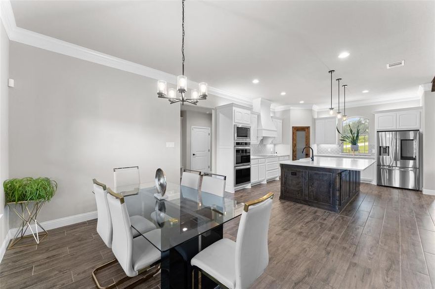 Set on a full acre in a quiet Azle neighborhood, this 4-bedroom, 2.5-bath home with a 3-car garage blends timeless design with modern comfort. The stone-and-brick exterior, arched entryways, and lush landscaping set the tone before you even step inside.

The foyer opens to a dedicated office framed by French doors, perfect for working from home. Just beyond, the living room stuns with vaulted ceilings, rustic wood beams, and a floor-to-ceiling stone fireplace. Oversized windows flood the home with natural light, offering peaceful views of the surrounding greenery.

The kitchen is a showstopper with crisp white cabinetry, quartz countertops, a massive island with rich wood detailing, double ovens, and a walk-in pantry with a glass door. Open sightlines connect seamlessly to the dining area and living space, making this the true heart of the home.

The primary suite is a retreat of its own, featuring a tray ceiling, spa-like bath with dual vanities, soaking tub, and walk-through shower, plus a custom walk-in closet with built-ins for ultimate organization. Secondary bedrooms are generously sized, and the laundry room with extra cabinetry and patterned tile adds both function and style.

Step outside to the covered patio, complete with a stone fireplace and ceiling fan, where you can unwind year-round while overlooking your spacious backyard. With a full acre of land, you’ll have room to garden, entertain, or simply enjoy the privacy.

Located within Azle ISD, families benefit from schools known for community spirit and strong programs. Beyond your doorstep, weekends can be spent on the waters of Eagle Mountain Lake, exploring nearby parks and trails, or enjoying Azle’s local dining and small-town charm—all while being a quick commute to Fort Worth.

This home was designed for both everyday living and unforgettable gatherings—style, space, and serenity all in one.