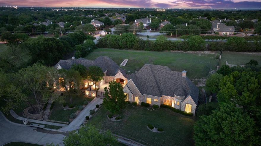 Located in the prestigious Chancellor Creek, this extraordinary estate offers a rare blend of scale, privacy, and resort-style living on nearly 1.5 acres. Just minutes from Stonebridge Ranch Country Club, the property delivers an unmatched lifestyle in one of McKinney’s most sought-after communities.
Designed for both grand entertaining and everyday comfort, the main residence spans with expansive living areas, soaring ceilings, and refined finishes throughout. The chef’s kitchen is equipped for elevated hosting, seamlessly connecting to multiple gathering spaces, a media room, and a custom bar area that invites unforgettable evenings at home. A standout feature of the property is the fully equipped guest residence, offering two full size bedrooms each with a private bathroom, private balcony overlooking the backyard, large upstairs mixed use living area, and its own kitchen and living quarters—ideal for multigenerational living, long-term guests, or income-producing opportunities.

The primary suite serves as a true retreat, offering generous space and privacy, while additional bedrooms provide flexibility for family, guests, or work-from-home needs. Step outside to your own private resort—complete with a pool and spa, covered outdoor living area, and a sprawling backyard with endless possibilities for recreation and entertaining.

Car enthusiasts and entertainers alike will appreciate the expansive 6-car garage, with 10 ft clearance for large vehicles, circular drive, and additional space designed for convenience and function. Zoned to highly acclaimed McKinney Independent School District, this one-of-a-kind estate delivers luxury, versatility, and privacy—all in a prime location.