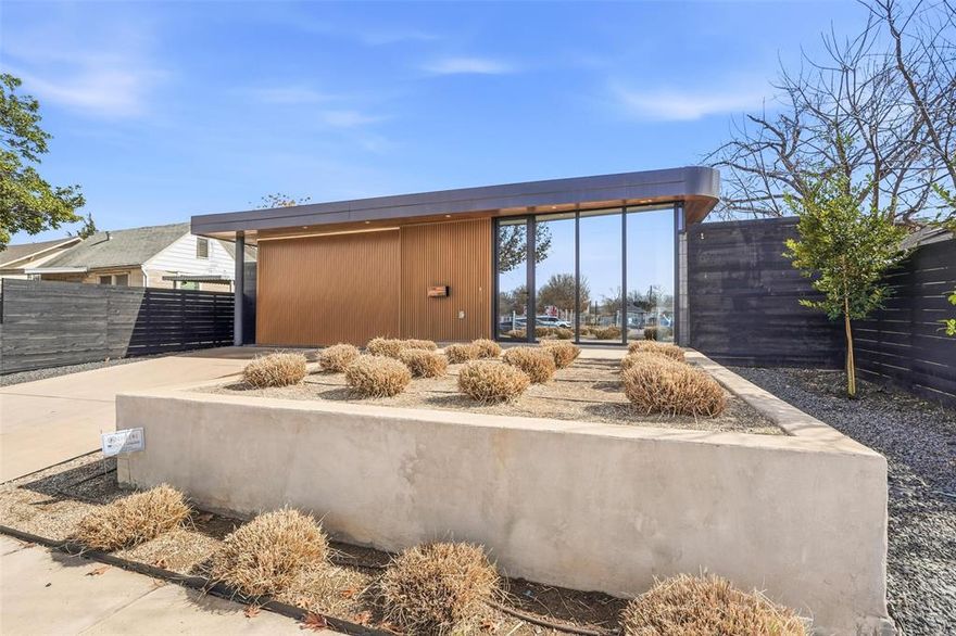This mid-century inspired modern home blends clean architectural lines with a welcoming, comfortable vibe. Designed by OBJEKT, a Josh Nimmo architectural firm, the home is thoughtfully planned around soft curves, natural light, and a seamless connection to the outdoors. Set high on its lot, the elevated front yard creates a sense of privacy and calm as you arrive. A unique horizontal rolling garage door allows for a dramatic floor-to-ceiling opening, and the 9-foot-tall glass entry makes a striking first impression. Inside, a beautifully designed vertical slatted paneled partition serves as both a design feature and functional storage. The main living spaces flow effortlessly toward the courtyard pool, which is surrounded by an Ipe wood deck—perfect for entertaining or relaxing. The kitchen is centered around a clean, modern island, with all Bosch appliances and pantry space tucked away behind custom cabinetry to keep the space open and uncluttered. The home’s private quarters are accessed by curving around the pool, with each bedroom offering its own en-suite bath. A flexible office or guest bedroom overlooks a lush green outdoor area, making it an ideal work-from-home retreat. The primary suite looks out over the pool and features a spa-like bath, double sinks with natural light, and custom closets. This is a home that feels architecturally special, yet easy to live in—designed for everyday comfort, entertaining, and enjoying indoor-outdoor living at its best.
