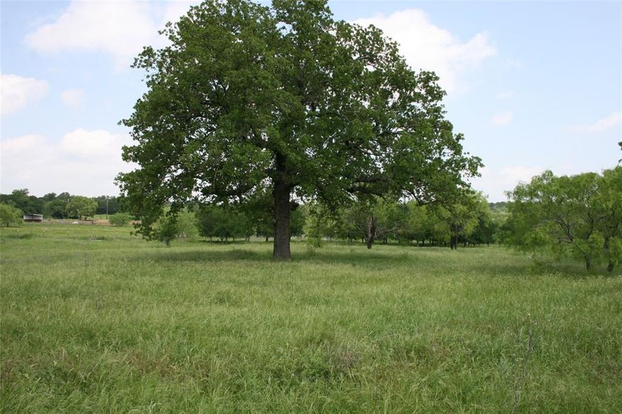 This property has several large oak trees, and also a nice pond. It is fenced on all sides of the pasture section. The six plus acre property goes all the way to Hwy 180. It has underground electric, and already has a water tap. Great location for country living, but is only minutes from downtown Mineral Wells. The hospital is on the west side of town, so you get there in less than five minutes. There are several horse places in this subdivision. There are restrictions like in any subdivision, but no HOA.