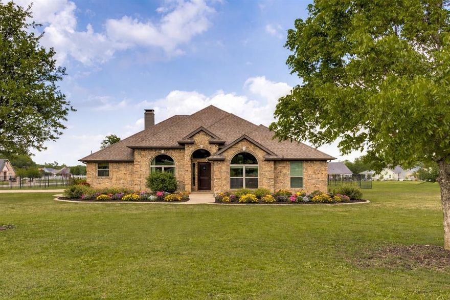 Discover a peaceful retreat in the heart of Gunter, where wide-open spaces and rolling countryside create the perfect setting for relaxed living. Located in the growing Hidden Lakes community, this beautifully updated 3-bedroom, 2-bath home with a dedicated study sits on a serene one-acre corner lot, offering both privacy and charm. Thoughtfully designed with a balance of functionality and style, the home features rich hardwood flooring and a fully renovated kitchen showcasing modern finishes and updated design. The bathrooms have been tastefully remodeled, including a stunning primary suite with a freestanding tub, separate shower, and refined cabinetry. Additional enhancements include custom built-ins in the living area, new windows, fresh interior paint, and a newly installed irrigation system. Step outside to your own private outdoor oasis. The expansive backyard, dotted with mature trees and enclosed by elegant wrought-iron fencing, offers endless possibilities. A spacious cedar-covered patio provides the ideal foundation for an outdoor kitchen and is perfectly suited for both quiet evenings and entertaining guests. Enjoy the best of country living with the convenience of a growing community—this exceptional property combines modern updates, generous space, and timeless appeal.