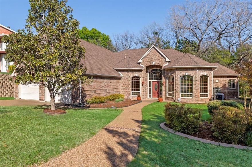 Experience the epitome of lakeside living in this custom one owner home located in the prestigious gated community of Chandler's Landing.  The home is located on an interior cul-de-sac lot, and backs up to a greenbelt full of cascading mature trees and green space. The interior of the home offers an open foyer leading to a formal dining room and a dedicated office with built in bookcase.  There is also a large family room with oversized windows offering an abundance of natural light throughout.  The kitchen features a large prep island, beautiful stained custom cabinets with custom storage and solid surface countertops.  The private primary suite with luxury bath has a huge walk in closet. Additionally there is an oversized utility room with folding counters, utility storage and room for a refrigerator or freezer.  The exterior is equally impressive, with a well-landscaped yard and a back yard greenbelt providing the perfect setting for relaxation. The proximity of this home allows for a short walk to the marina and Lake Ray Hubbard which makes this location a boater's paradise.  This exclusive neighborhood offers 24-hour guarded access, a private beach with lake access, community parks, walking paths, pools, tennis courts, and a picturesque clubhouse