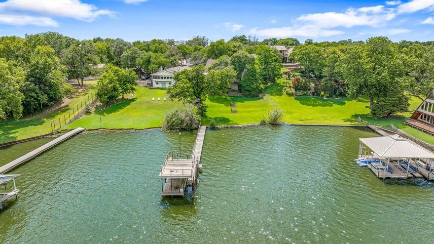 'COME SAIL AWAY' on Texas's #1 sailing lake-Eagle Mountain Lake. This home is waiting for new creative ideas to make it a top Estate on arguably one of EML's top 3 streets. This .70 acre, over 4100 sqft., 5 bedrooms-4 baths, over 100' water frontage, and deep water at the dock are just a few of the benefits this property has to offer. There is a separate workshop with an office above for quiet time or naps. If your knees are shaking because of the potential vision of what can be created, there is an elevator that can get you to the different levels. The nationally recognized Fort Worth Boat Club is a 4-5 minute boat ride or car drive away. If you do the updating, the possibilities are endless for a family lakeside Revival Resort. Enjoy living on a street where Eagles, Beatles, and John Denver ('come fill up your senses') have visited, and the Fort Worth Star Telegram has done articles on the impressive history of ownership of Dickson Road. The 'Crystal Blue Persuasion' will keep your blood pressure at a perfect level. Relax on the lakeside decks in the Hot Tub and become 'Comfortably Numb'. Come Explore For Additional Benefits Hidden In Plain Sight. This property is a 'catch' worth bragging about. 
Eagle Mountainonians have a saying that this beauty will get you so excited and tongue-tied you will not be able to CLINK THEARLY!! Call if you don't get this, and we will also set up a showing!